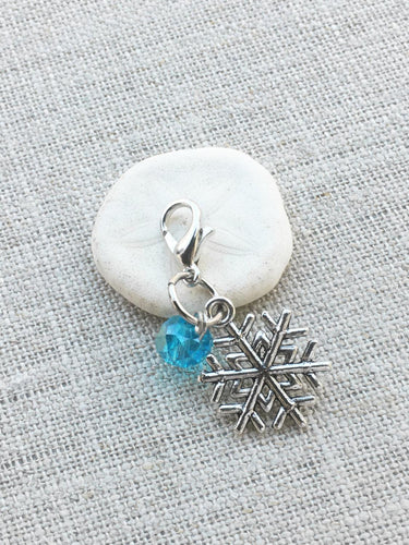 sfront view of silver tone snowflake place holder with ice blue acrylic bead detail and lobster claw closure