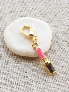 closeup front view of gold toned enamel pink lipstick lobster claw markers