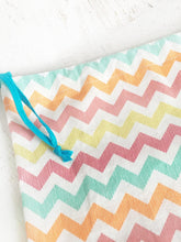 turquoise blue drawstring is used to close this colorful project bag