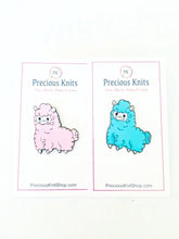 pictured is pink and blue sheep enamel pins together side by side for comparison