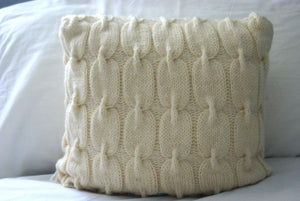 close up the cable knit pattern used to knit this pillow sham