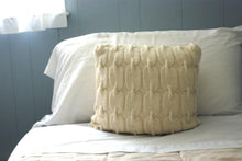 cable knit pillow shown displayed on a bed for decor