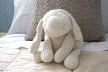 finished white fluffy dog toy made by this knitting pattern