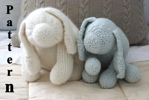 close up pictures of 2 knit dogs sitting on a Childs bed one blue and one white dog