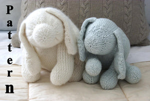 close up pictures of 2 knit dogs sitting on a Childs bed one blue and one white dog